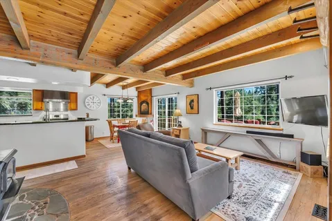 a living room with furniture and large windows