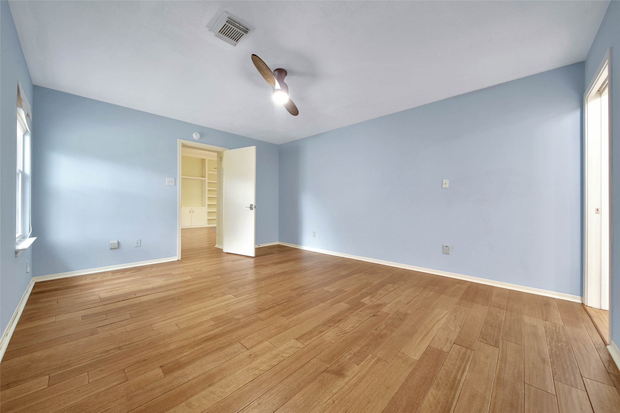 5010 Cupids Bower Court Spring, TX 77388 - Photo 15 of 40 an empty room with wooden floor and windows