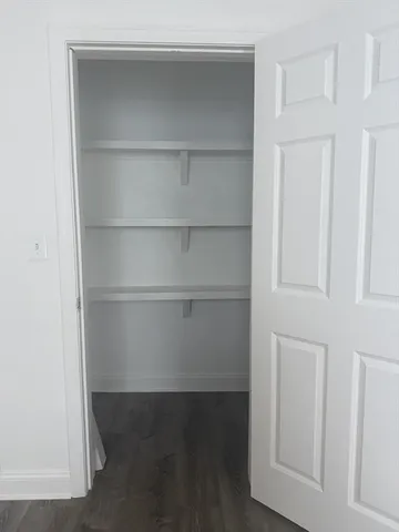 a view of an empty walk in closet