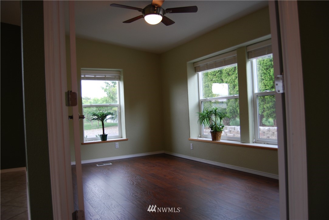 12 Caudill Road Omak, WA 98841 - Photo 15 of 37 a view of an empty room with wooden floor and a window