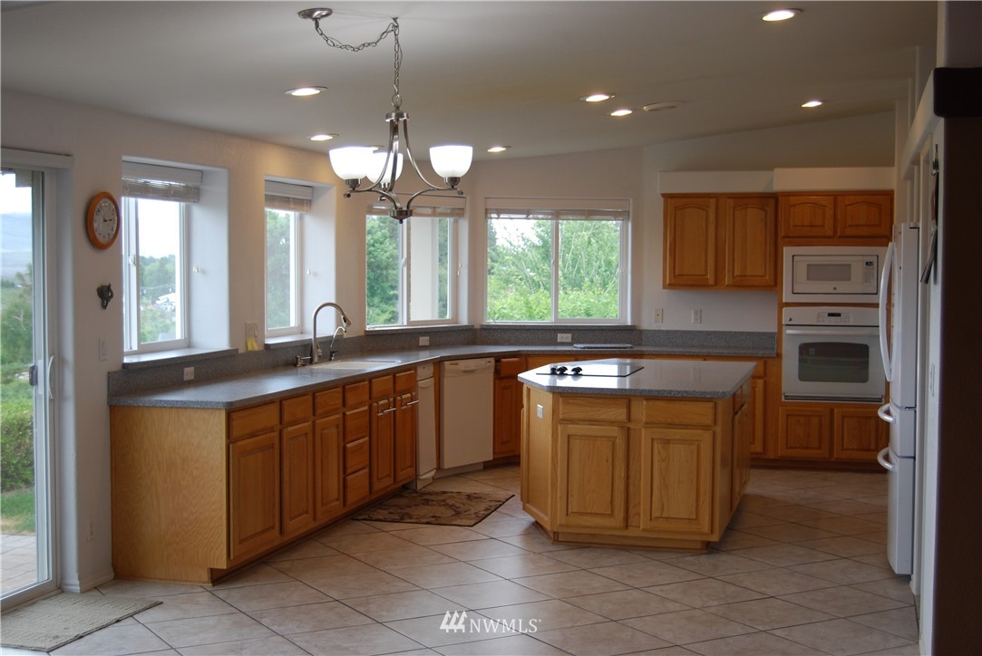 12 Caudill Road Omak, WA 98841 - Photo 21 of 37 a kitchen with stainless steel appliances granite countertop a sink and a stove