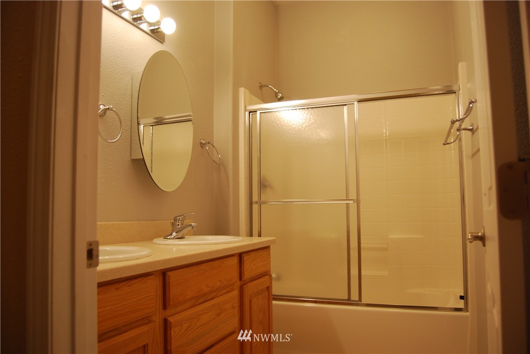 12 Caudill Road Omak, WA 98841 - Photo 29 of 37 a bathroom with a shower a sink and a mirror