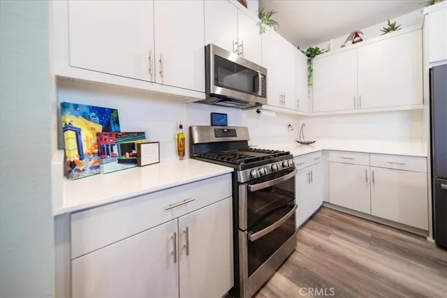 a kitchen with stainless steel appliances a refrigerator sink and cabinets
