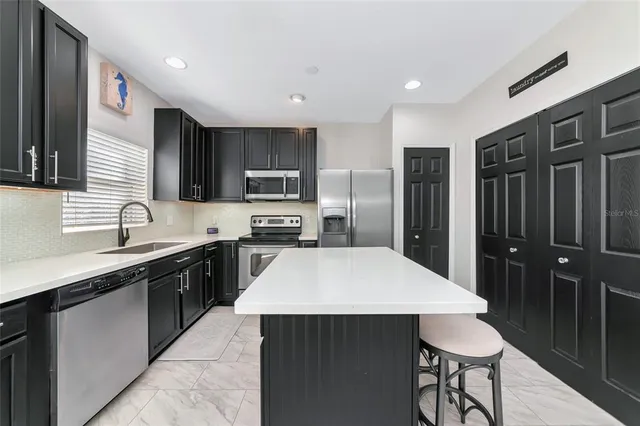 a kitchen with a sink stove and refrigerator
