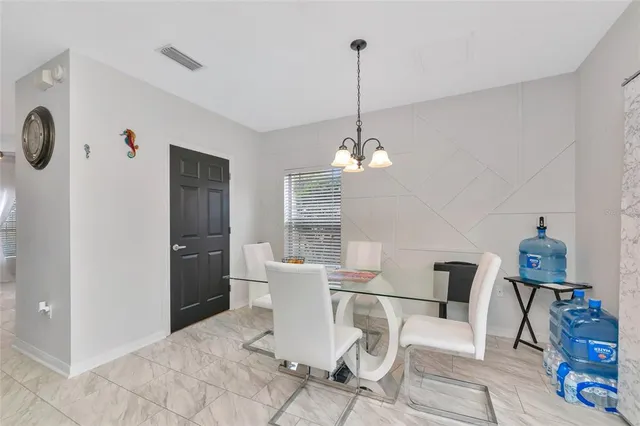 a spacious bedroom with a bed and a chandelier