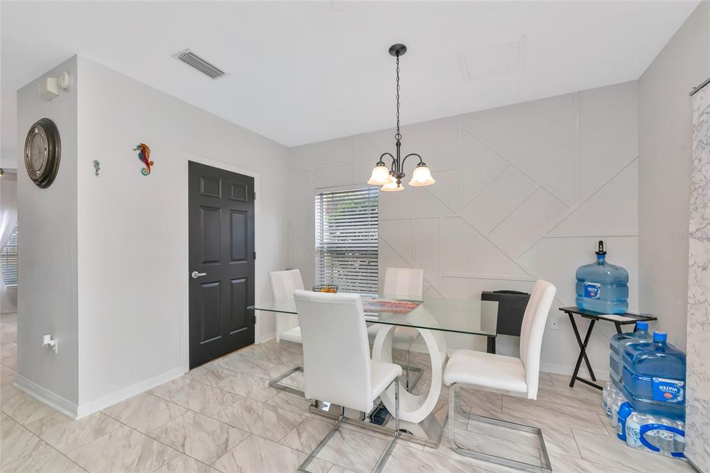 6205 Flagfish Court Lakewood Ranch, FL 34202 - Photo 18 of 67 a view of a dining room with furniture