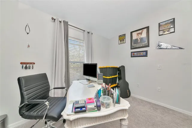 a bedroom with a bed and a tv on the dresser