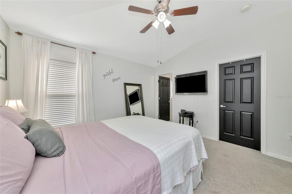 6205 Flagfish Court Lakewood Ranch, FL 34202 - Photo 23 of 67 a bedroom with a bed and a flat screen tv
