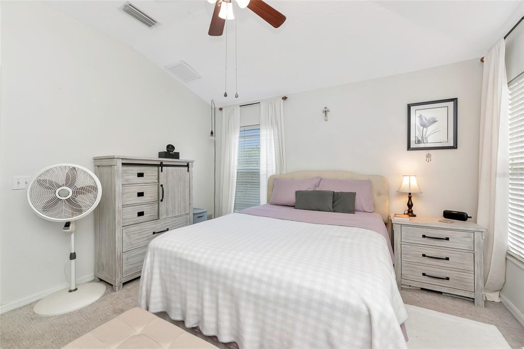 6205 Flagfish Court Lakewood Ranch, FL 34202 - Photo 25 of 67 a bedroom with a bed a chandelier and a closet