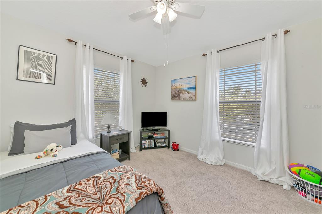 6205 Flagfish Court Lakewood Ranch, FL 34202 - Photo 27 of 67 a bedroom with a bed and a tv on the dresser