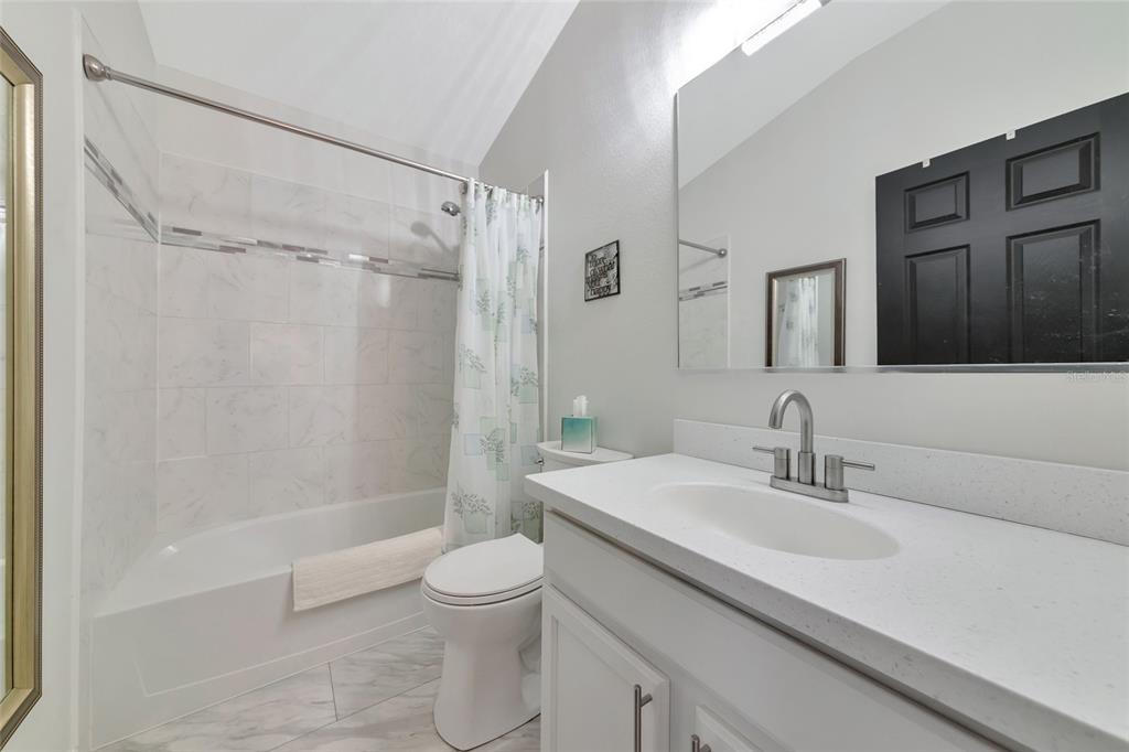 6205 Flagfish Court Lakewood Ranch, FL 34202 - Photo 29 of 67 a bathroom with a sink a toilet and shower