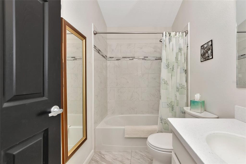 6205 Flagfish Court Lakewood Ranch, FL 34202 - Photo 30 of 67 a bathroom with a shower a bathtub and a shower