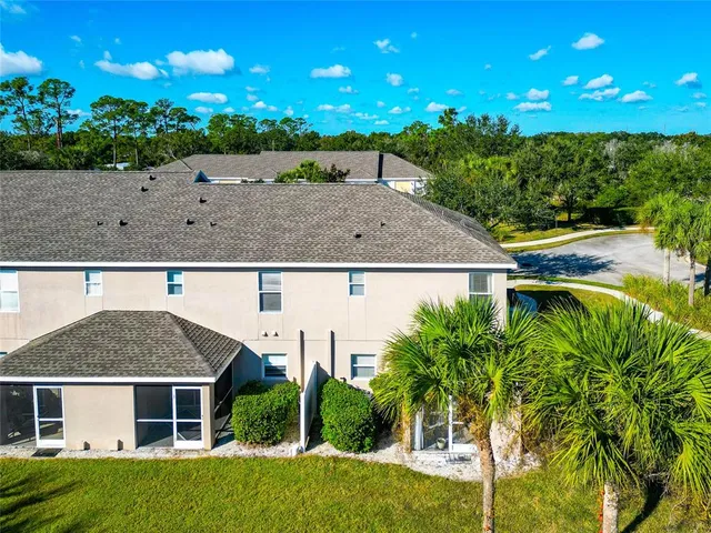 an aerial view of residential houses with outdoor space and swimming pool