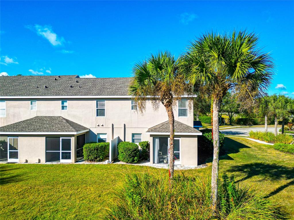 6205 Flagfish Court Lakewood Ranch, FL 34202 - Photo 47 of 67 a view of a white house with a big yard and palm trees