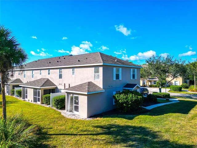 an aerial view of a house with swimming pool and outdoor seating
