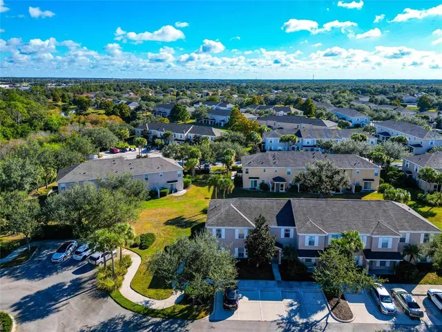 an aerial view of residential houses with outdoor space and pool