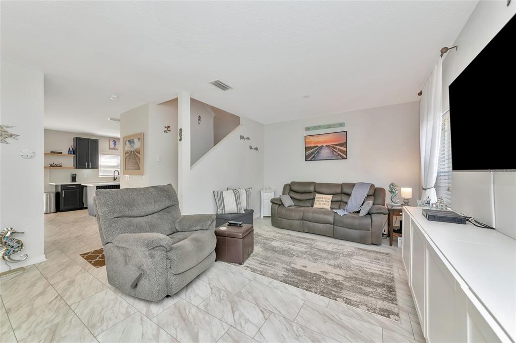 6205 Flagfish Court Lakewood Ranch, FL 34202 - Photo 6 of 67 a living room with furniture and a flat screen tv