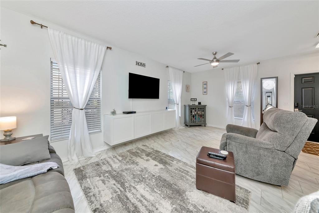 6205 Flagfish Court Lakewood Ranch, FL 34202 - Photo 7 of 67 a living room with furniture and a flat screen tv