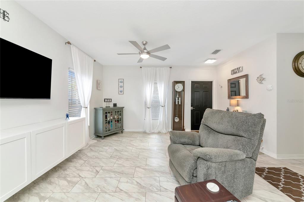6205 Flagfish Court Lakewood Ranch, FL 34202 - Photo 8 of 67 a living room with furniture and a flat screen tv
