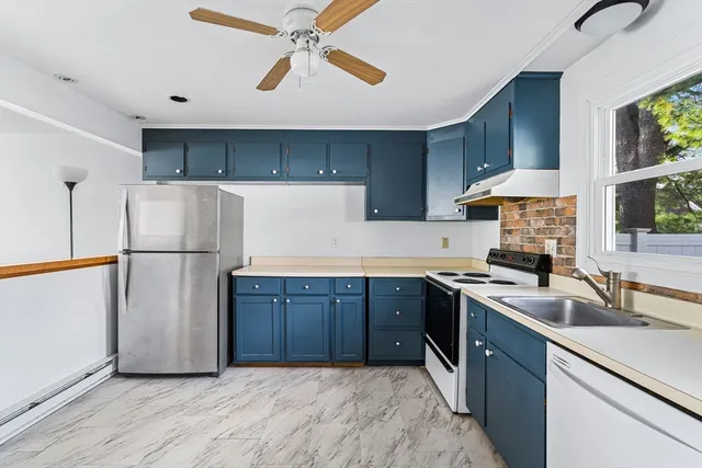 a kitchen with stainless steel appliances granite countertop a refrigerator a sink dishwasher a stove and a refrigerator