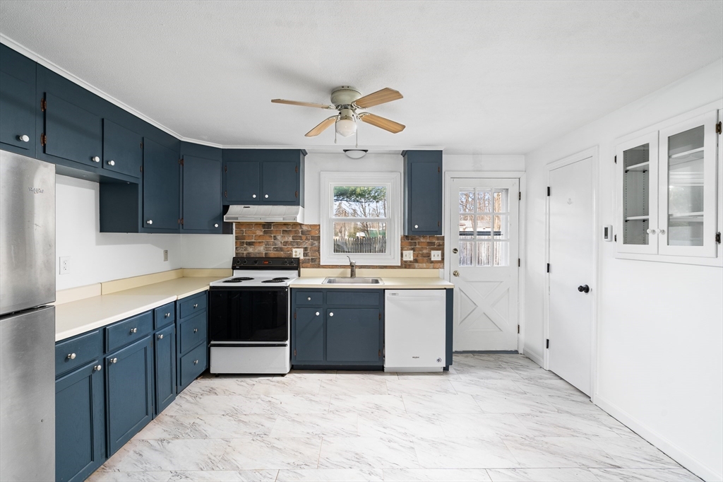 41 South Street, Unit 11 Easthampton, MA 01027 - Photo 12 of 30 a kitchen with stainless steel appliances a sink a stove a refrigerator cabinets and a window