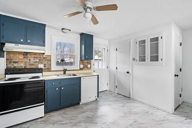 a large kitchen with cabinets and stainless steel appliances