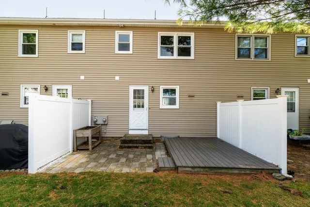 a view of a house with backyard and wooden fence