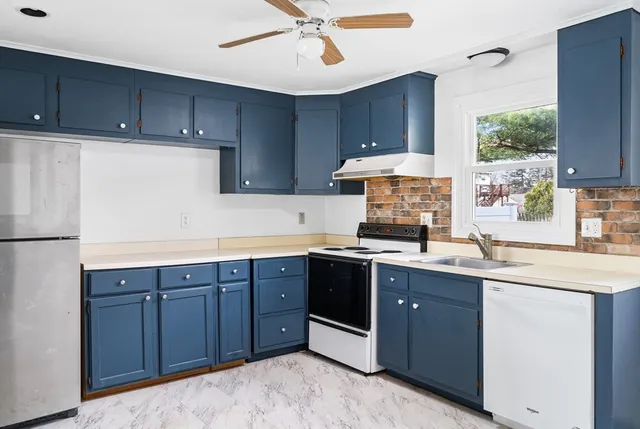 a kitchen with a sink cabinets and window