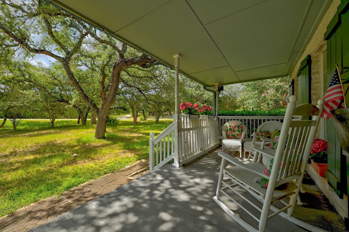 a view of a porch with furniture and garden