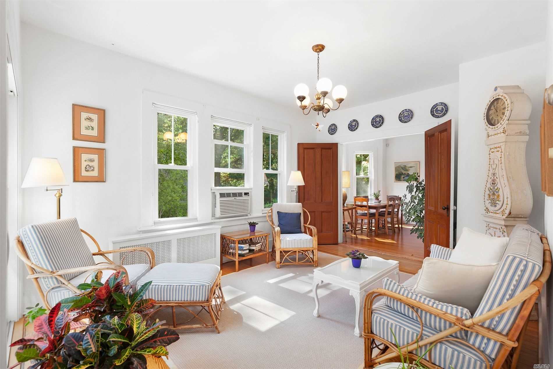 178 South Country Road Remsenburg, NY 11960 - Photo 1 of 1 a living room with furniture chandelier and window
