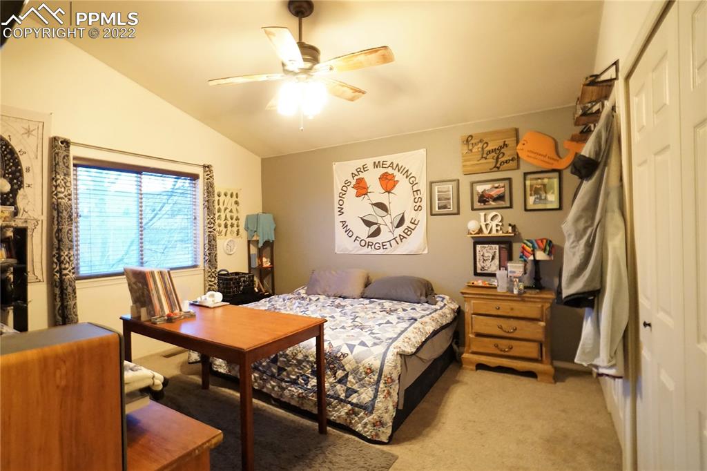 980 Mesa Valley Road, Unit 108 Colorado Springs, CO 80907 - Photo 11 of 21 a bedroom with a bed and a table in it