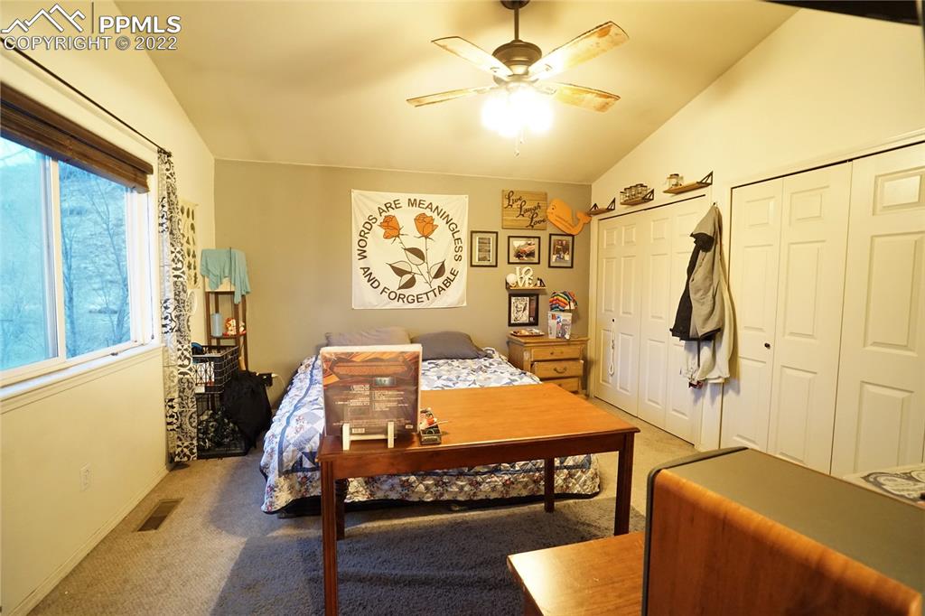 980 Mesa Valley Road, Unit 108 Colorado Springs, CO 80907 - Photo 13 of 21 a bedroom with a bed and a table