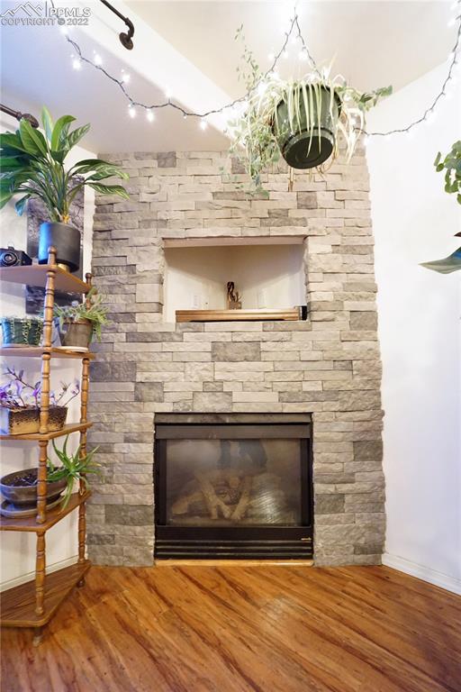 980 Mesa Valley Road, Unit 108 Colorado Springs, CO 80907 - Photo 5 of 21 a fireplace with a wooden floor
