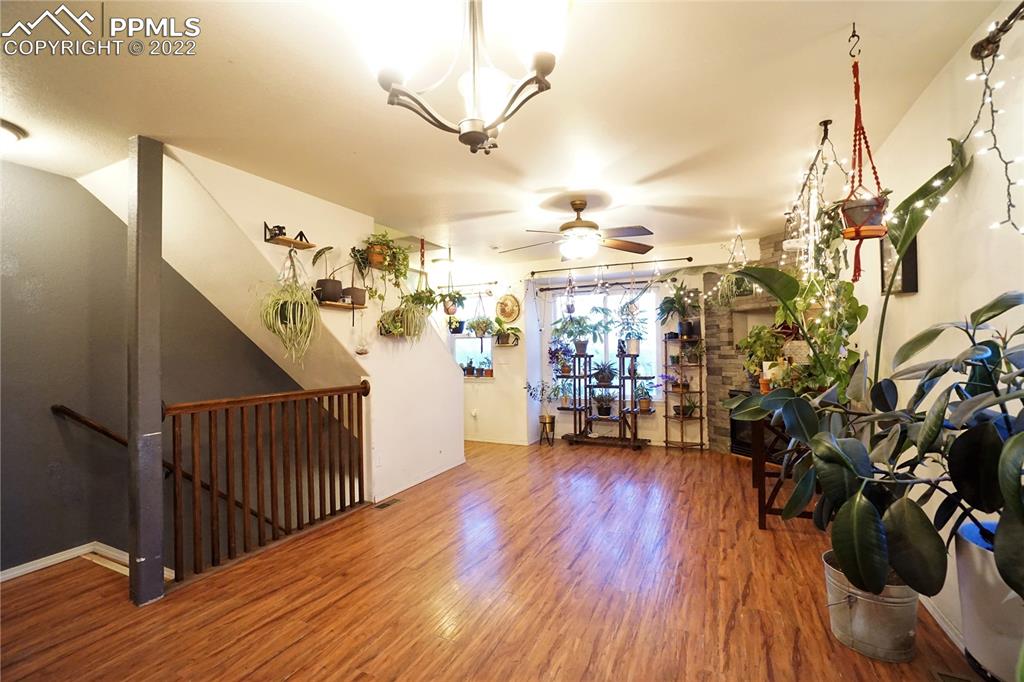 980 Mesa Valley Road, Unit 108 Colorado Springs, CO 80907 - Photo 6 of 21 a view of a livingroom with furniture and wooden floor