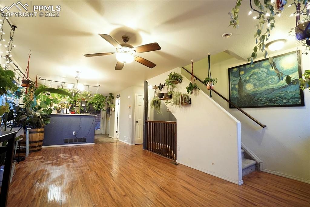 980 Mesa Valley Road, Unit 108 Colorado Springs, CO 80907 - Photo 10 of 21 a view of a room with wooden floor and ceiling fan