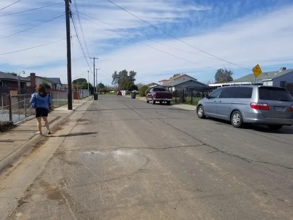a view of road with card parked on road