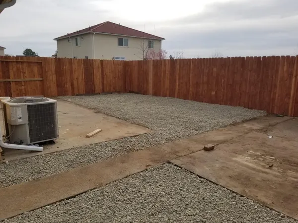 a view of a backyard with table and chairs