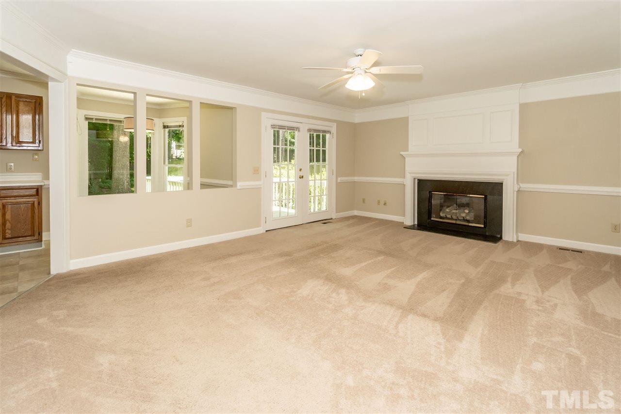 8113 Coleraine Court Raleigh, NC 27615 - Photo 12 of 28 Family Room with Gas Log fireplace and door leading onto back deck.