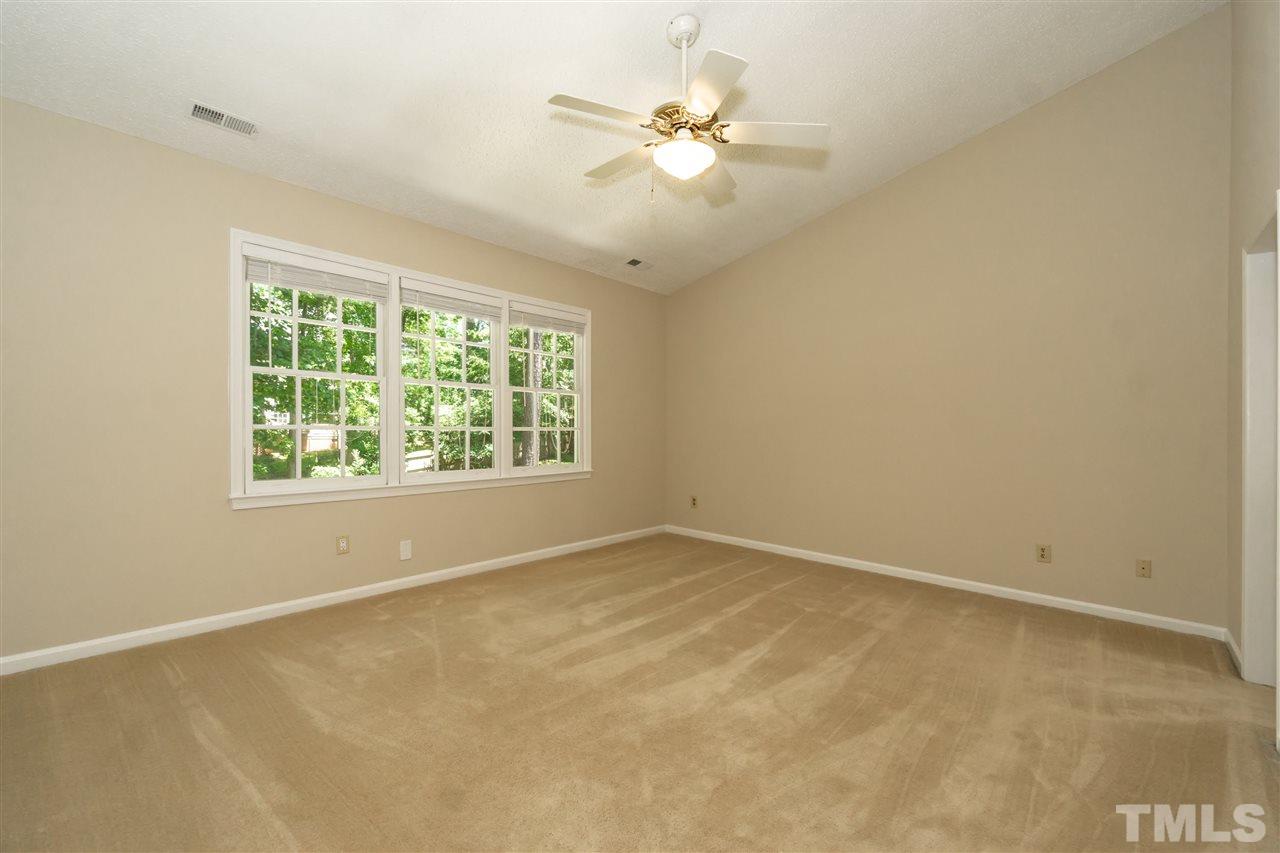 8113 Coleraine Court Raleigh, NC 27615 - Photo 20 of 28 Master Bedroom with Cathedral Ceilings and wonderful natural light.
