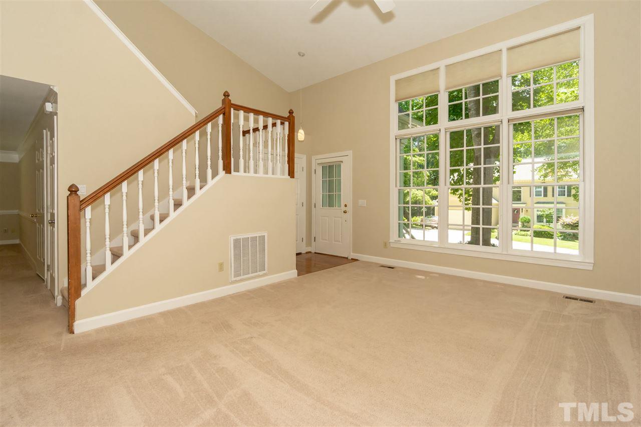 8113 Coleraine Court Raleigh, NC 27615 - Photo 6 of 28 Open Living Room with cathedral ceilings and large bright triple window, providing lots of natural light.
