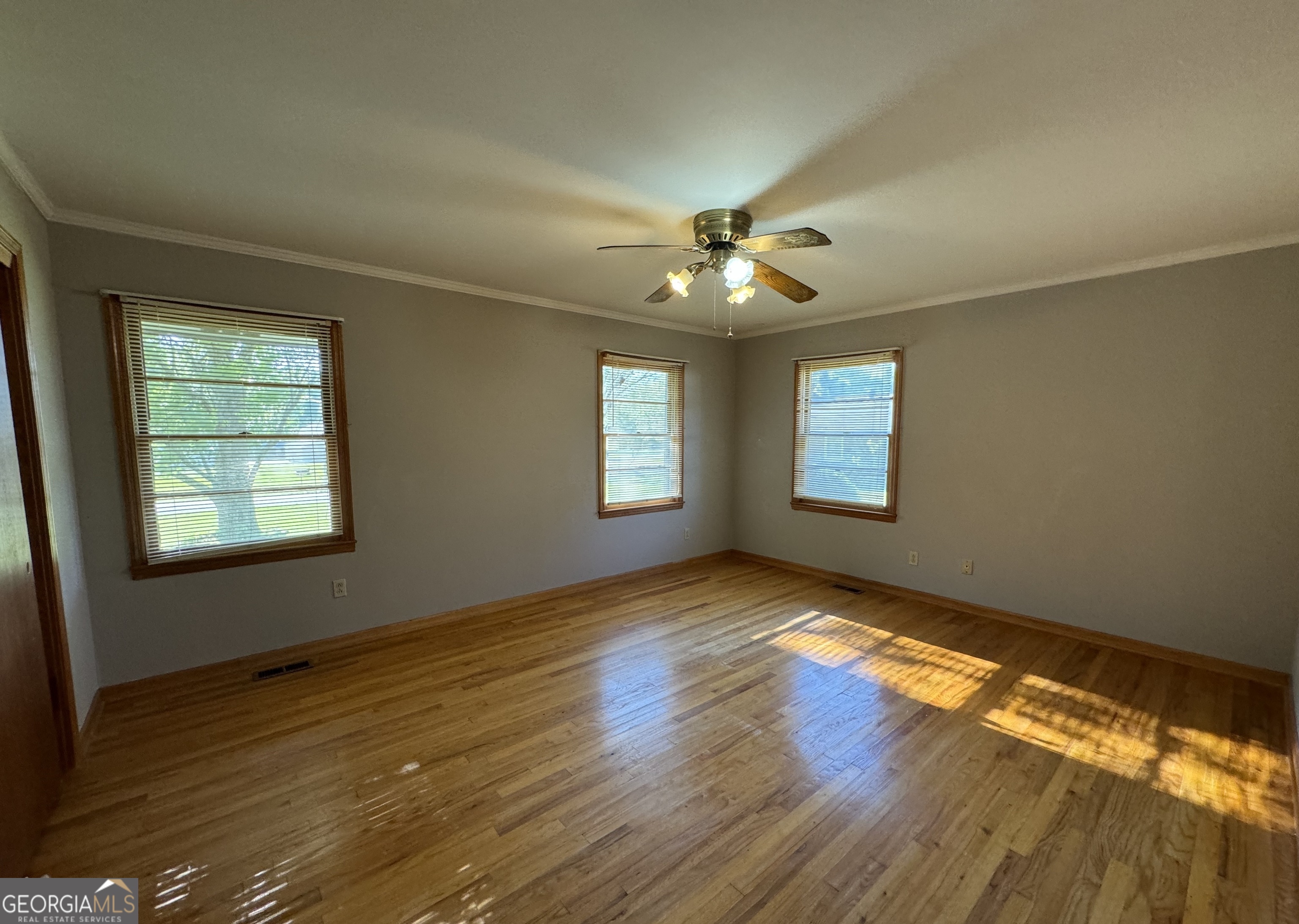 133 McCaskill Drive Jackson, GA 30233 - Photo 12 of 26 a view of an empty room with wooden floor and a window