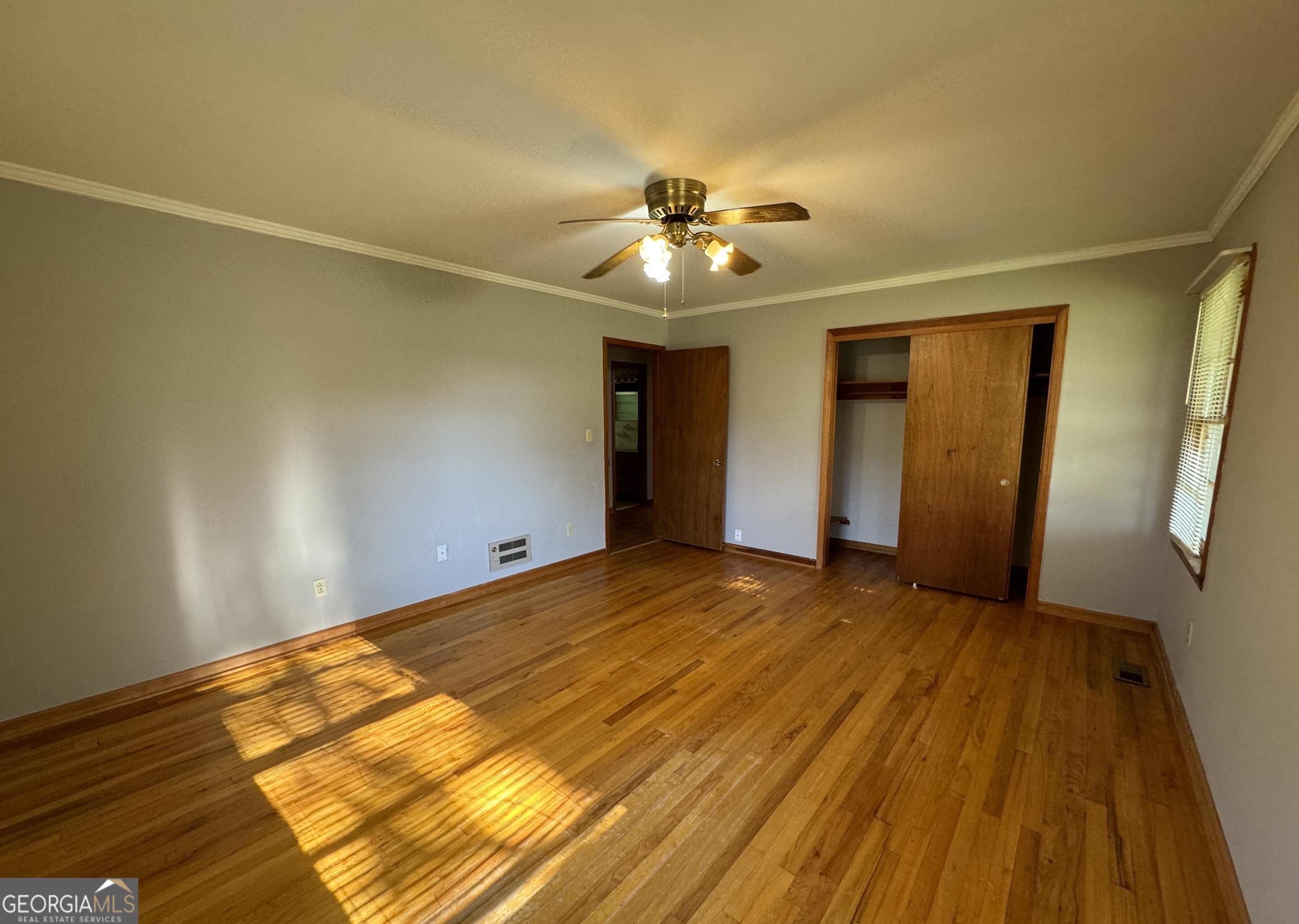 133 McCaskill Drive Jackson, GA 30233 - Photo 13 of 26 a view of an empty room with wooden floor and a window