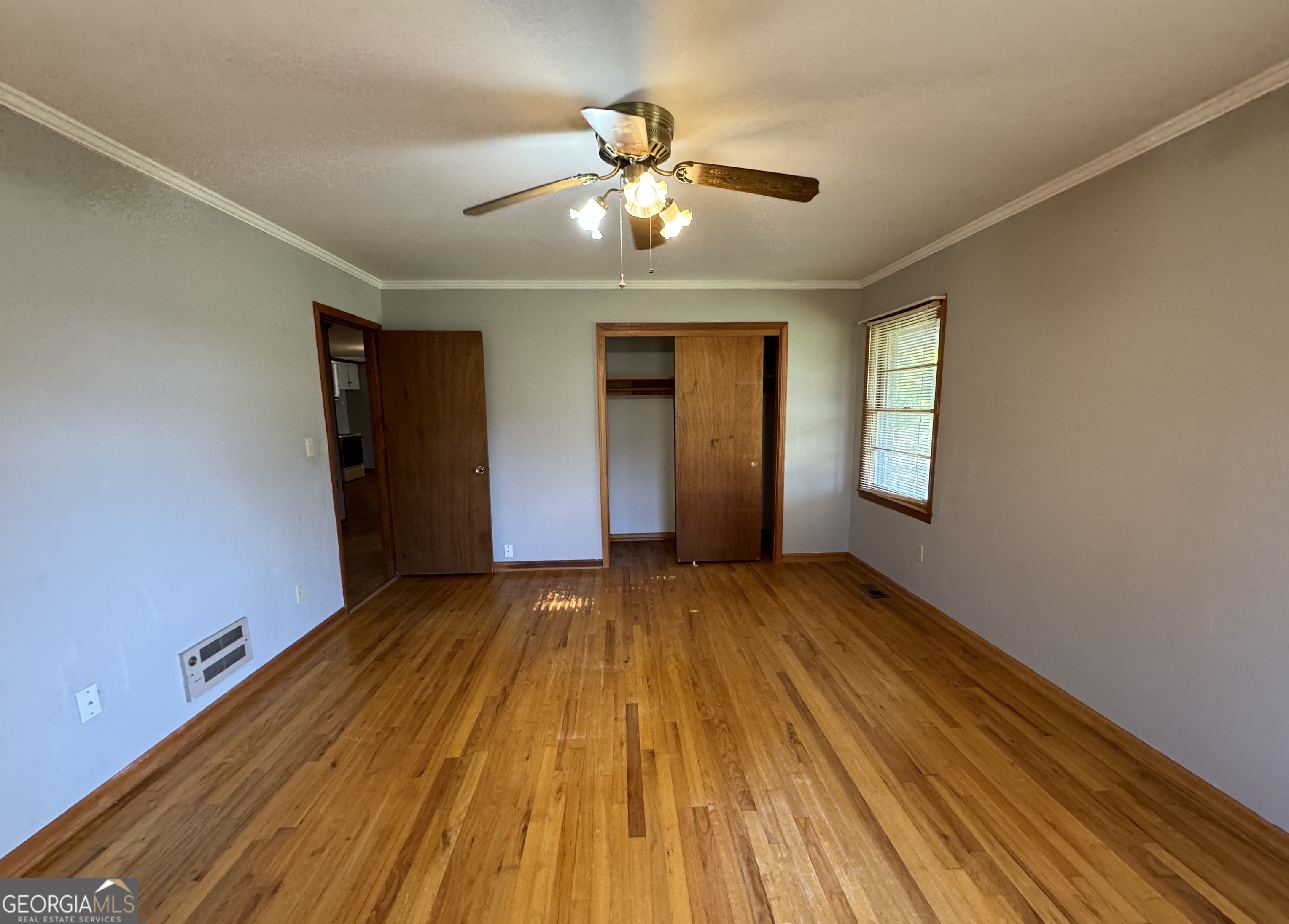 133 McCaskill Drive Jackson, GA 30233 - Photo 14 of 26 a view of an empty room with window and wooden floor