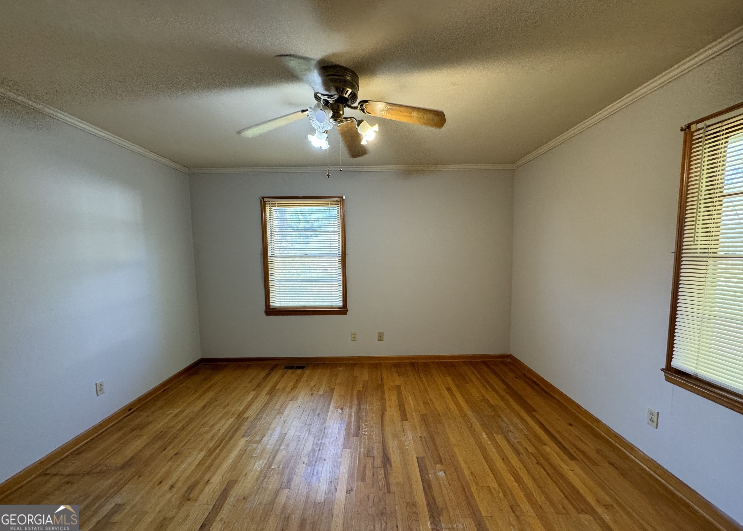 133 McCaskill Drive Jackson, GA 30233 - Photo 20 of 26 a view of empty room with wooden floor and fan