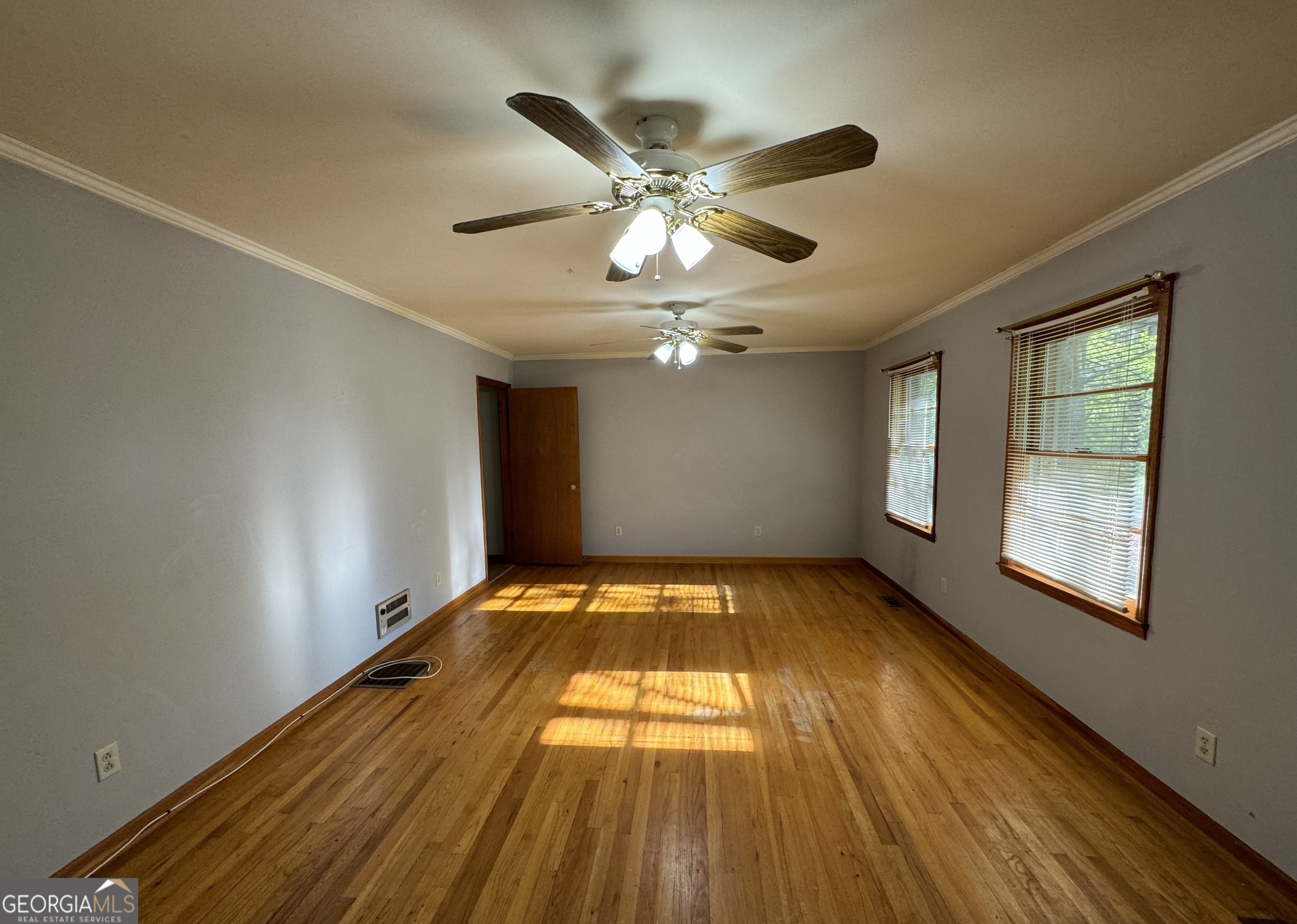 133 McCaskill Drive Jackson, GA 30233 - Photo 4 of 26 a view of an empty room with wooden floor and a window