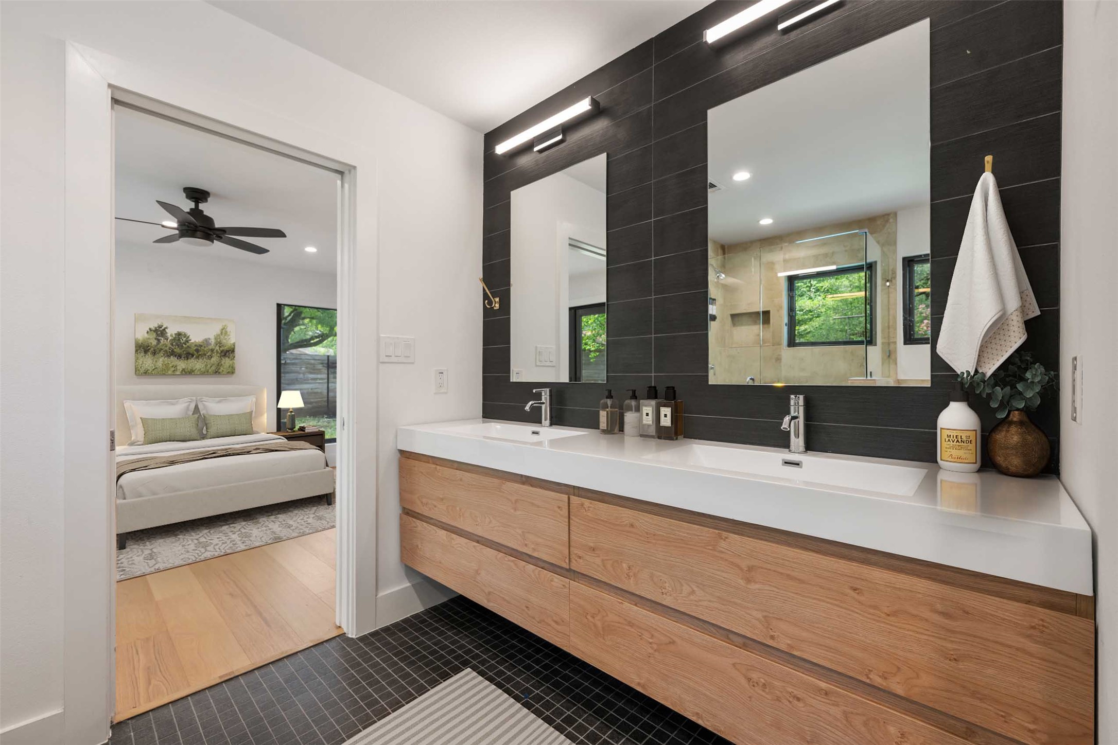8900 Point W Drive Austin, TX 78759 - Photo 28 of 40 A well-lit primary bathroom features a double vanity and a sleek, contemporary design.