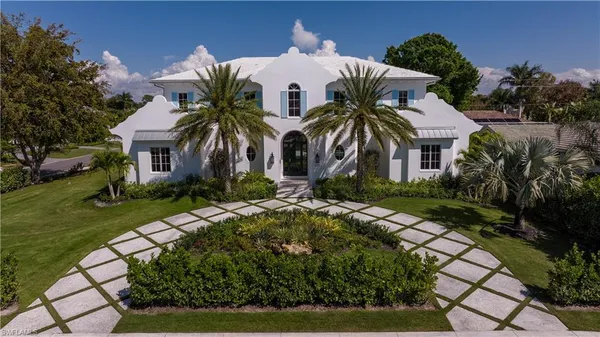 a front view of multiple houses with yard