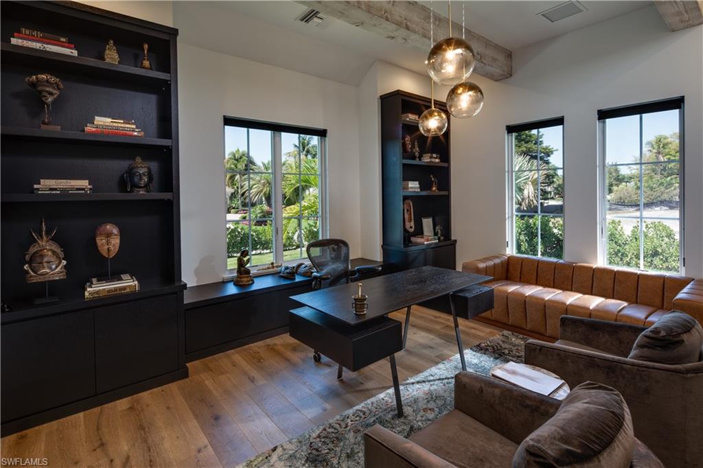 3770 Crayton Road Naples, FL 34103 - Photo 14 of 26 a living room with furniture and a large window