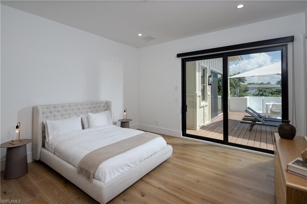 3770 Crayton Road Naples, FL 34103 - Photo 18 of 26 a bedroom with a bed and a large window