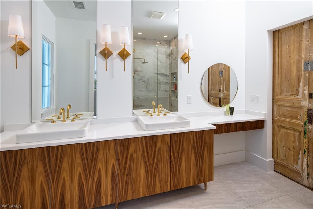 3770 Crayton Road Naples, FL 34103 - Photo 21 of 26 a bathroom with a double vanity sink mirror and shower
